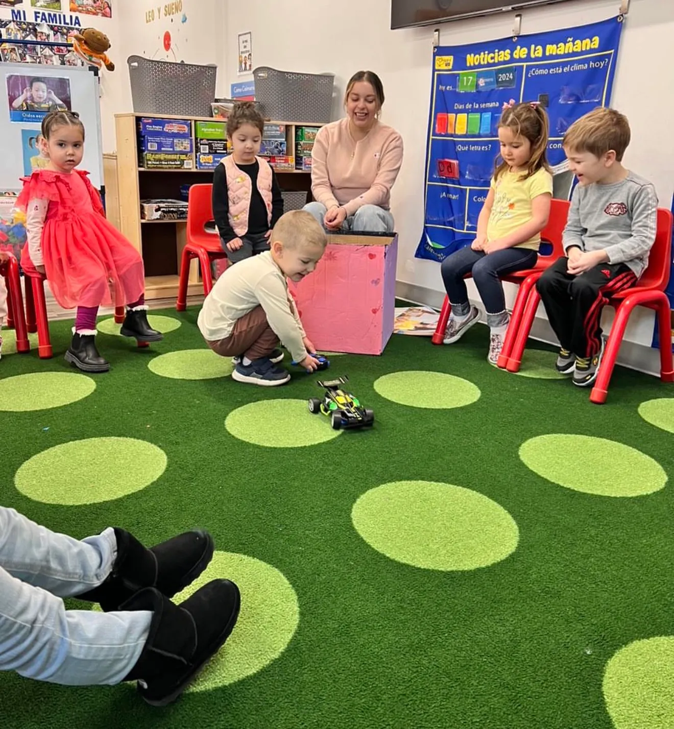 Children gathered for a hands-on activity on the classroom rug at AFA in Woodbury